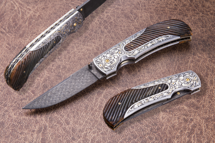 The "Zenith". Fitted with a 3" Turkish Twist Damascus blade forged by Doug Ponzio, engraved 416 SS bolsters engravved by Brian Bump, and fluted mammoth ivory scales. Available for immediate delivery $4895.00. Click on image for hi res picture.