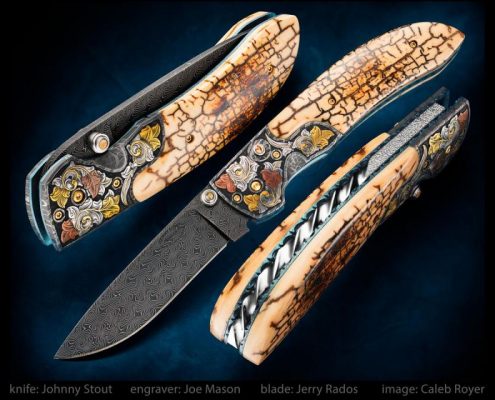 My popular double action automatic folder with a Jerry Rados, 3 3/8 inch Turkish Twist Damascus blade, Robert Eggerling mosaic damascus bolsters engraved with 24 karet gold and pure copper inlay by Joe Mason... exhibition grade museum fit crackle mammoth ivory scales, and fileworked backspacer and liners. Overall length is 7 5/8 inches. This one has been sold, I am accepting orders on a similar model.