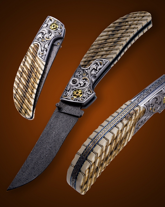 The "Vaquero" Double Action Auto, fitted with a 3 3/4" blade of Doug Ponzio's Turkish Twist Damascus, fluted Mammoth ivory scales with 14k gold wire inlays, and hand engraved bolsters and backspacer by Master Engraver, Wes Griffin. Available for immediate delivery $6950.00. Click on image for hi res picture.